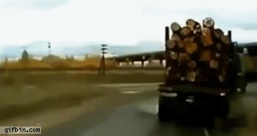 Truck almost tips with wood logs