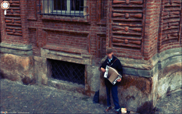 Musician on the corner playing Google Maps