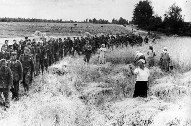 German POWs marching east. 1944 Note the woman showing a fist