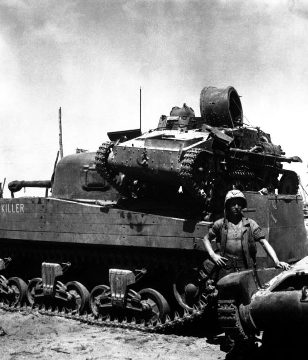 An American M4 tank carrying a small type 94 Japanese tank