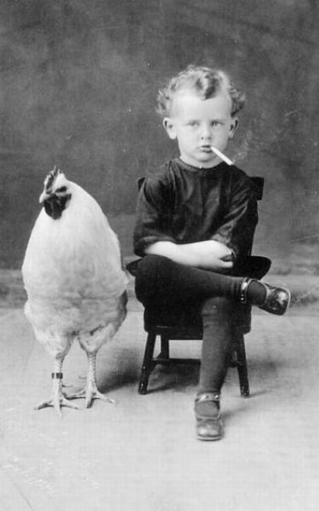 Old Weird Photos Boy smoking by rooster