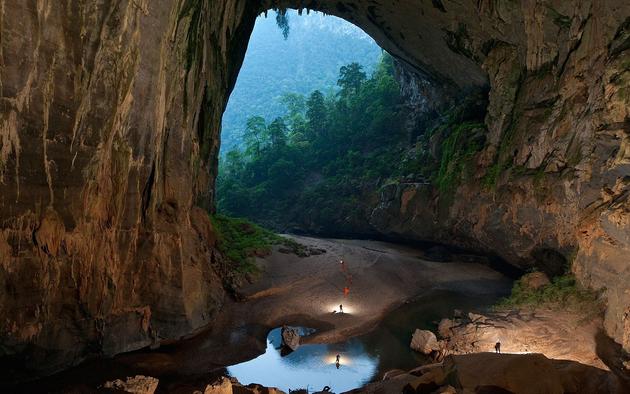 Enterance to the Son Doong Cave with small lake inside.