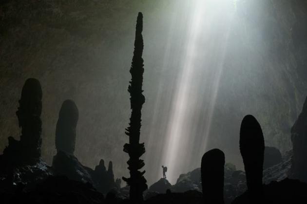 Rock formations stand and hang tall inside of Son Doong Cave