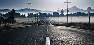 A foggy road in the morning HD Wallpaper